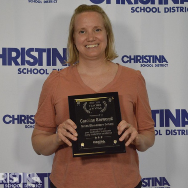 Photo of Caroline Szewczyk Teacher of the Year Smith ES holding award